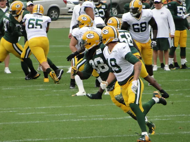 As we can see in the image there are group of people playing over here, grass, fence and in the...