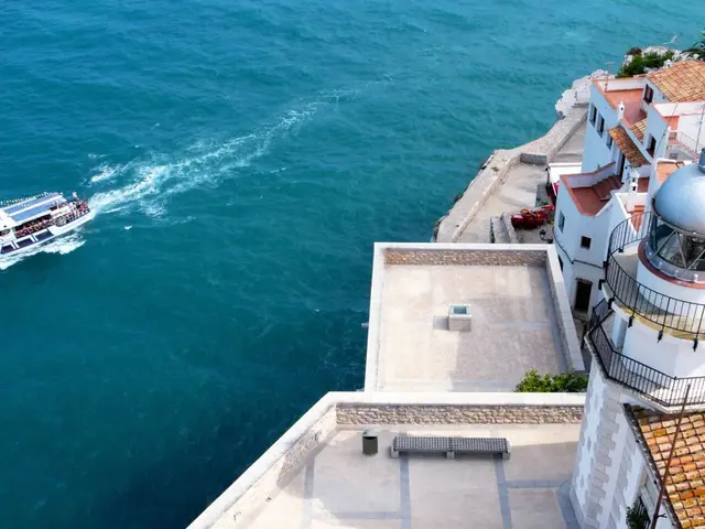 On the right side there are many buildings with windows and railings. Also there are trees. On the...